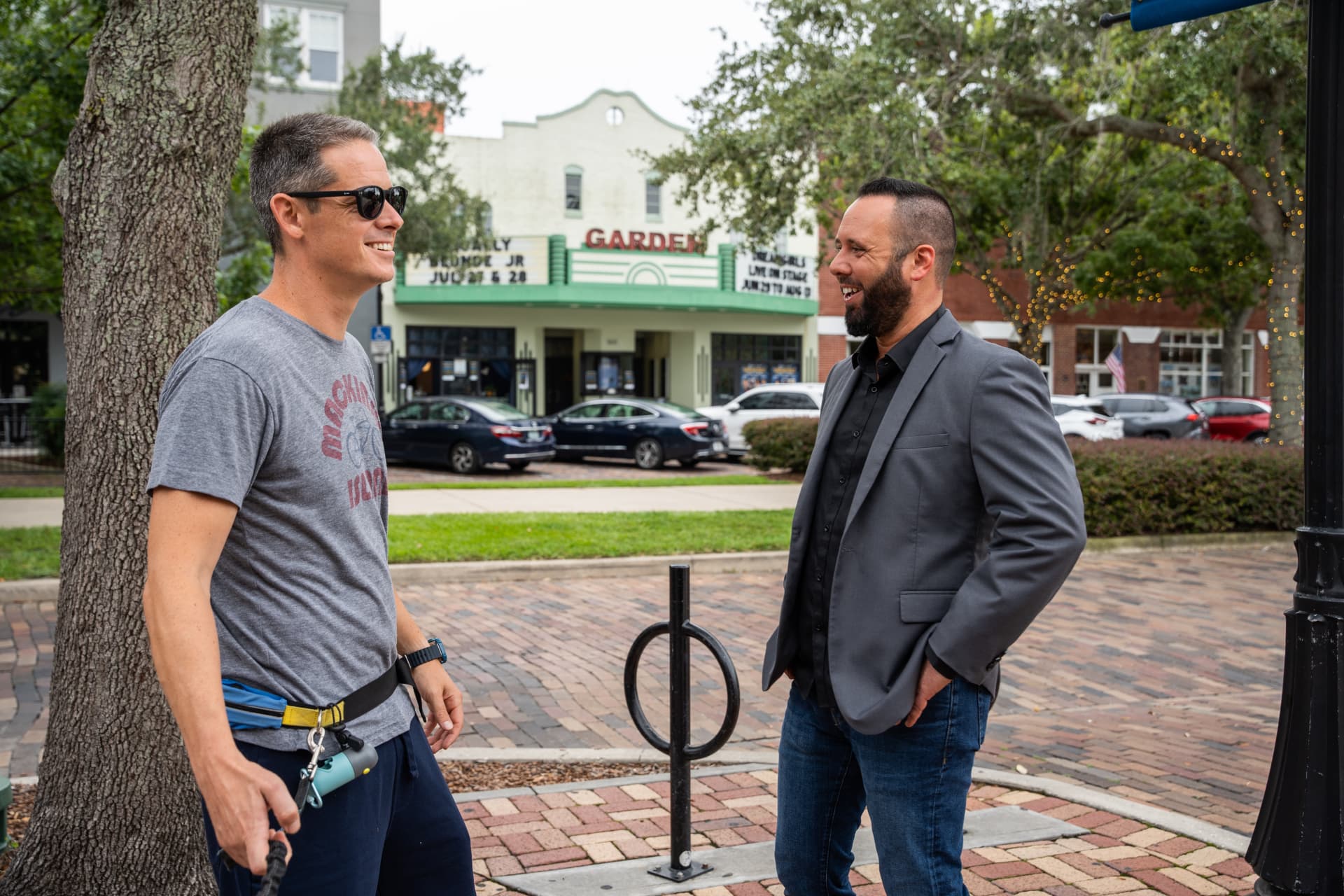 Austin Arthur talking with a resident outside the Garden Theatre on Plant Street in downtown Winter Garden, Florida
